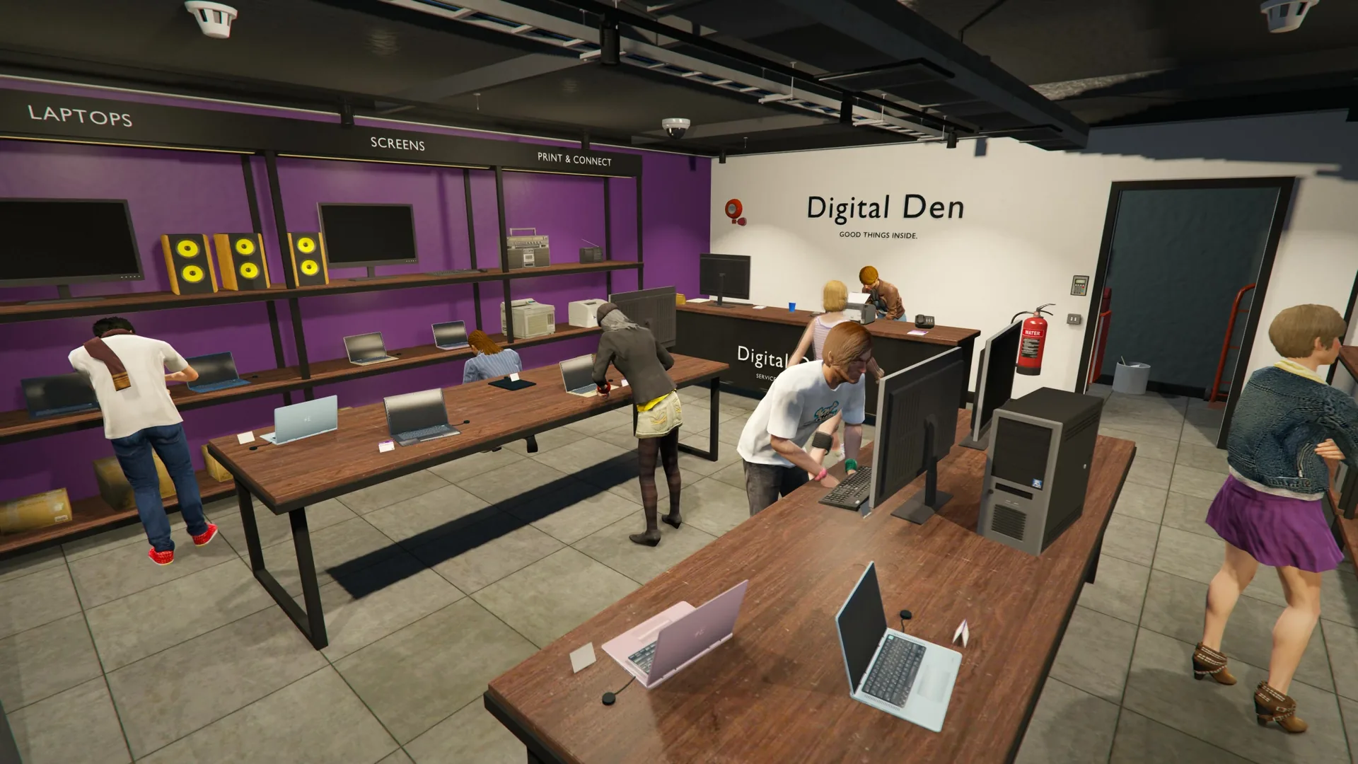 Players browsing laptops, monitors and printers on display in the Digital Den electronics store