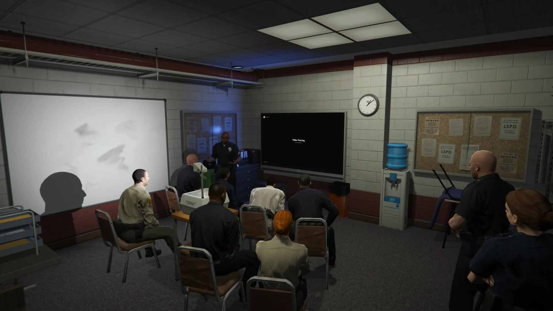 Police officers in a briefing room watching a presentation cast to a wall-mounted TV
